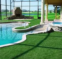 Picture of backyard full of artificial turf that has been infilled with Sharpshot